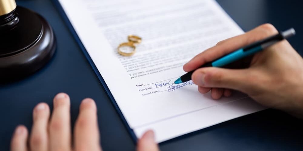 How Do I File for Divorce in Michigan Young couple consulting with a lawyer in court to sign a divorce agreement