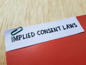 The written implied consent laws on table background.