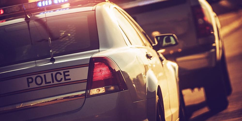 Police-Cruiser-with-Flashing-Lights Will I Lose My License After a DWI/OWI in Michigan?