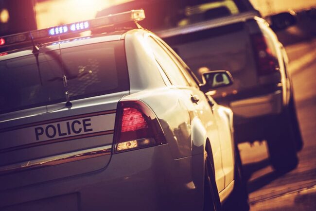 Police-Cruiser-with-Flashing-Lights Will I Lose My License After a DWI/OWI in Michigan?