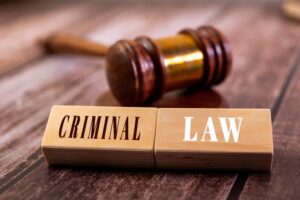 Wooden blocks spell out "Criminal Law" beside a gavel