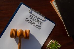 Serious Accusation Filed: Felony Charges Document with Gavel Display